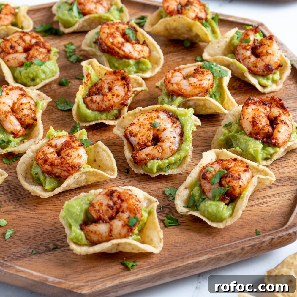 Slow-Cooker Christmas Wassail Recipe for Festive Parties 11 Shrimp guacamole bites on a wooden platter.