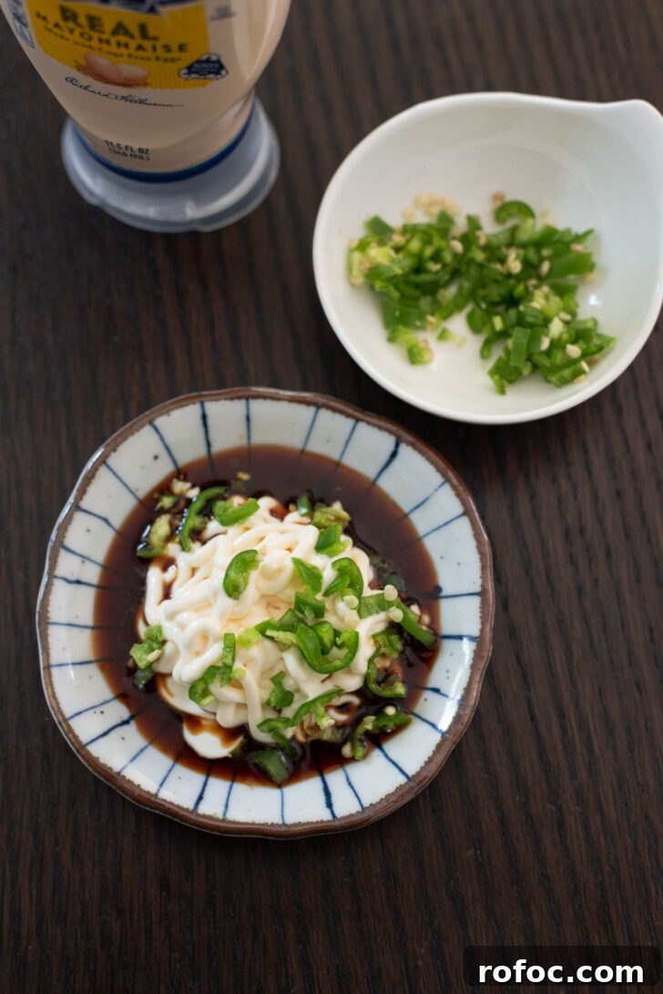 Korean-Style Jwipo Fish Jerky: Spicy Dried Fish Snack Guide 11 soy sauce, mayonnaise, chopped green chili are combined as a dipping sauce.