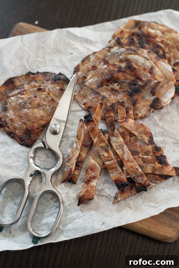 Korean-Style Jwipo Fish Jerky: Spicy Dried Fish Snack Guide 10 Roasted jwipo is cut into strips with a scissor.