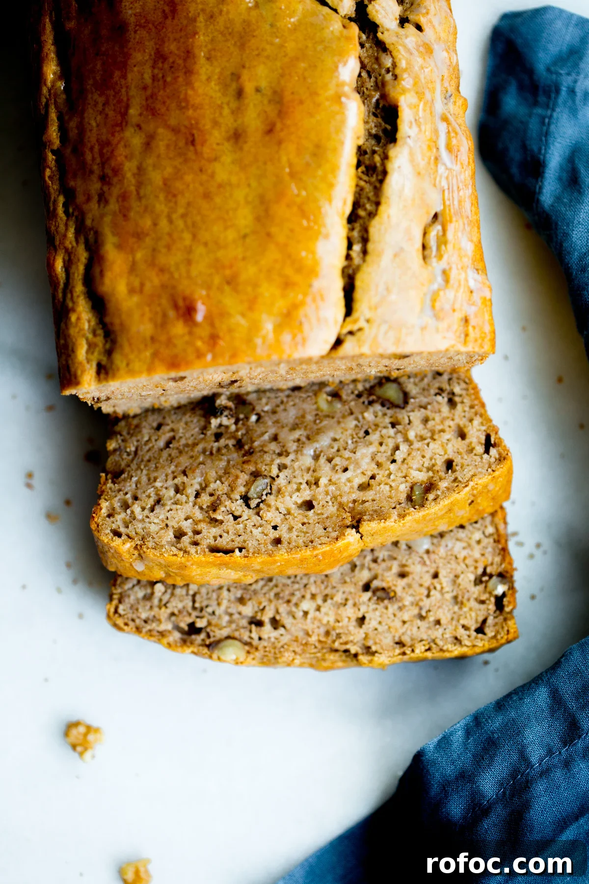 overhead photo of a loaf of healthy no added sugar banana bread with two slices cut