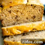 close up photo of a loaf of healthy no added sugar banana bread with two slices cut