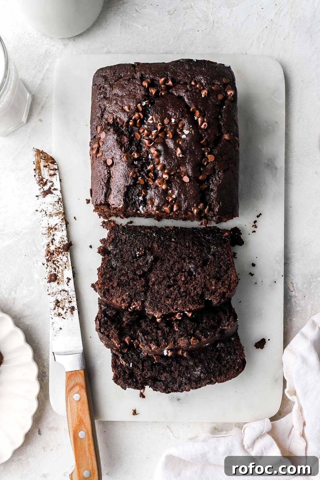 Decadent Chocolate Banana Bread Recipe with Melted Chips 12 sliced chocolate banana bread with mini chocolate chips on top