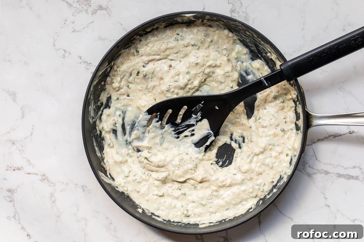 Creamy Baked Crab Dip with Garlic and Parmesan 8 cream cheese mixture for crab dip in skillet.