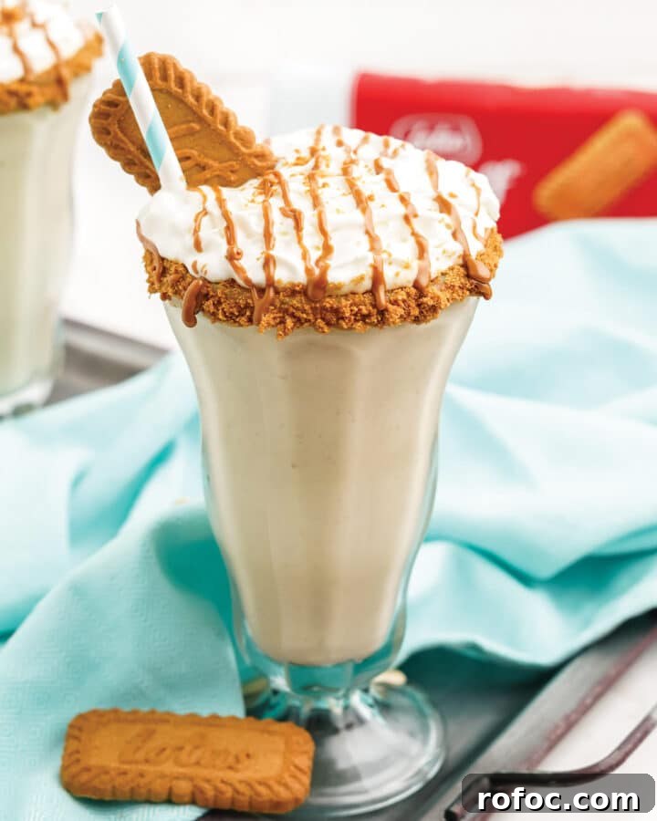 Cookie butter milkshake on the table with aqua napkin.