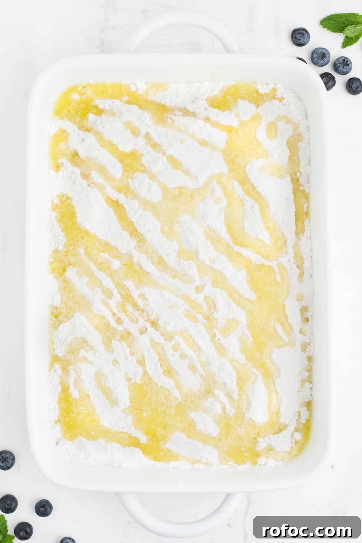Blueberry Cake Mix Cobbler: Quick, Moist Dessert Recipe 6 Butter drizzled over the top of the dry cake mix and blueberry filling layers.