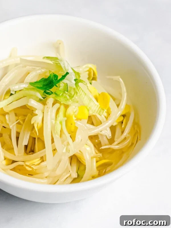Authentic Doenjang Jjigae Recipe: Korean Soybean Paste Stew Guide 11 Korean soybean sprout side dish, kongnamul muchim, in a white bowl