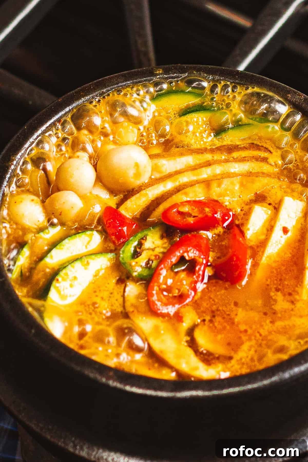 Authentic Doenjang Jjigae Recipe: Korean Soybean Paste Stew Guide 3 Doenjang jjigae with vegetables, tofu, and peppers boiling in a pot.