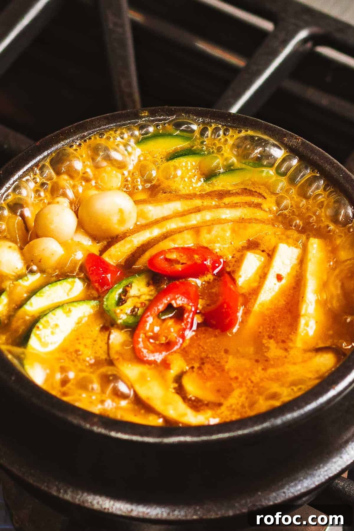 Authentic Doenjang Jjigae Recipe: Korean Soybean Paste Stew Guide 7 Doenjang jjigae with Korean soybean paste, vegetables, tofu, and peppers boiling in a pot.