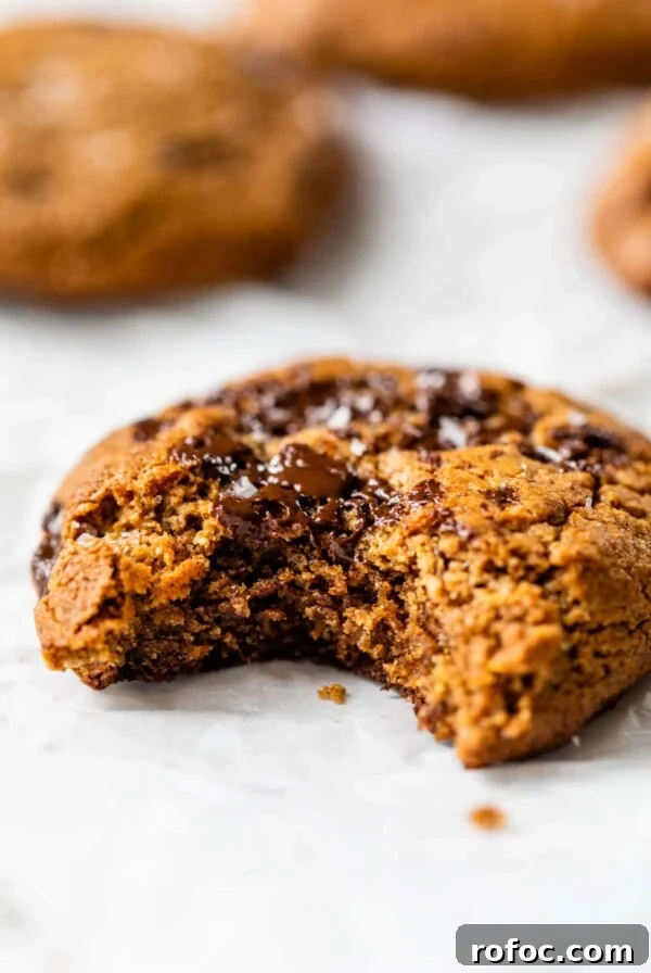 close-up side view of a flourless chocolate chip cookie with a bite taken out