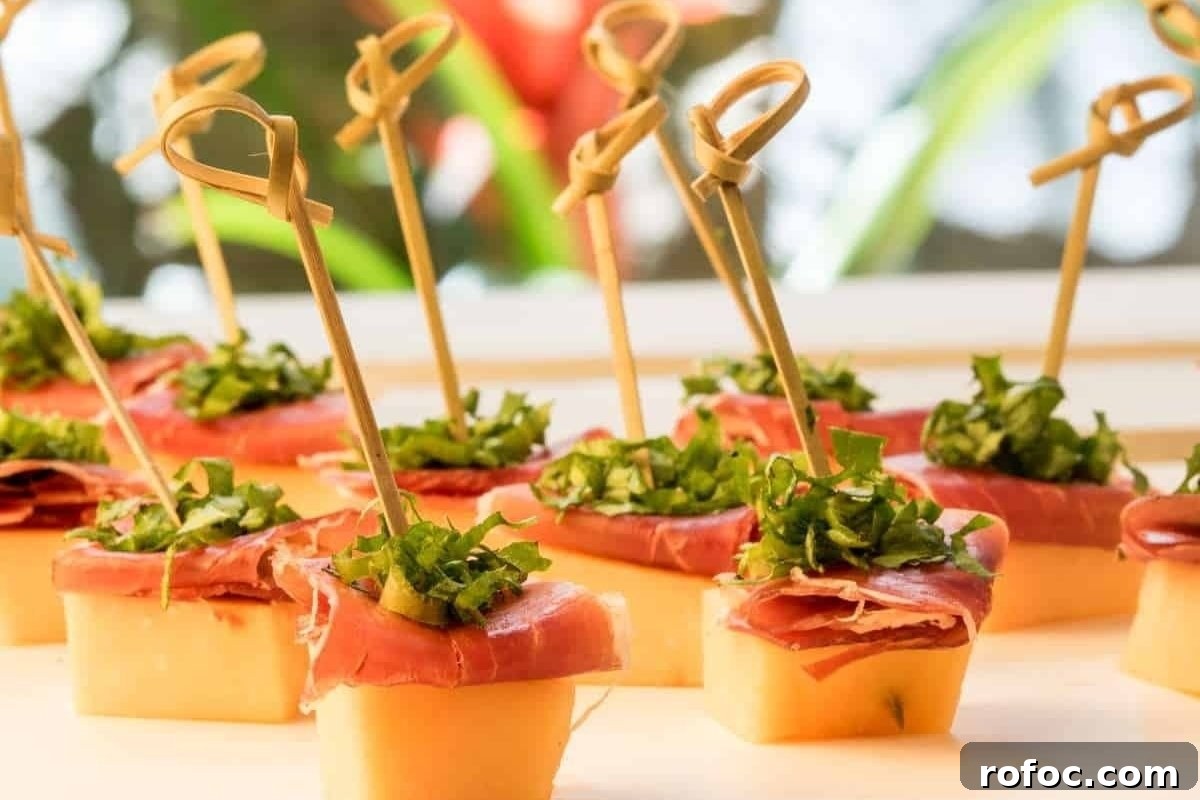 50 Quick Dinner Ideas to Make When You Don't Feel Like Cooking 18 Appetizers featuring prosciutto and garnished herbs on small bread slices, secured with decorative toothpicks, presented as bites for dinner on a tray.