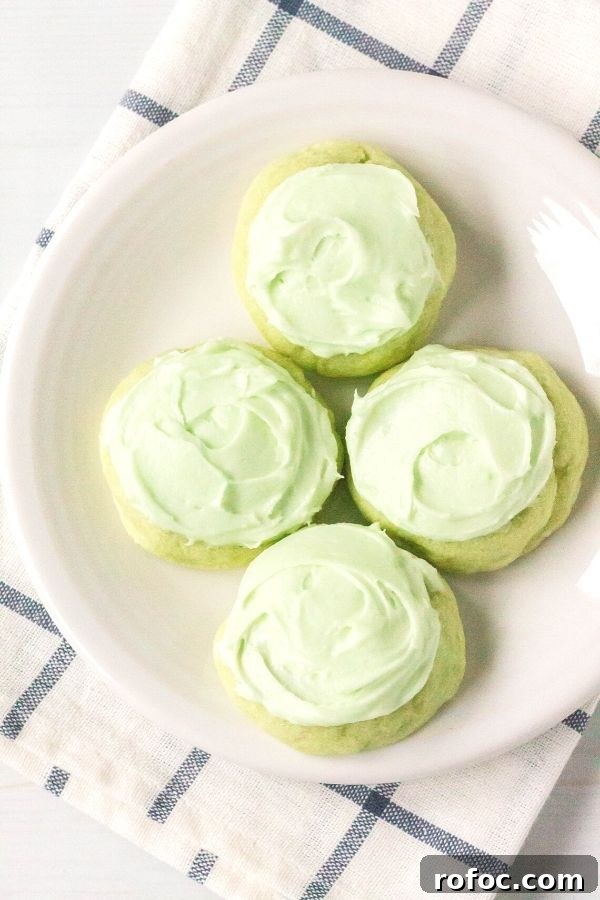 Zesty Lime Jello Sugar Cookie Recipe for Bright, Chewy Cookies 3 a white plate with lime jello sugar cookies topped with pale green icing