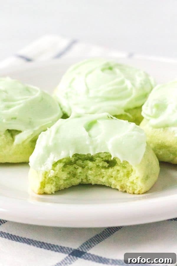 Zesty Lime Jello Sugar Cookie Recipe for Bright, Chewy Cookies 8 four lime jello cookies on a white plate, with a bite taken out of the front cookie