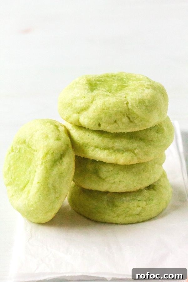 Zesty Lime Jello Sugar Cookie Recipe for Bright, Chewy Cookies 9 a stack of lime jello sugar cookies on a piece of white parchment paper