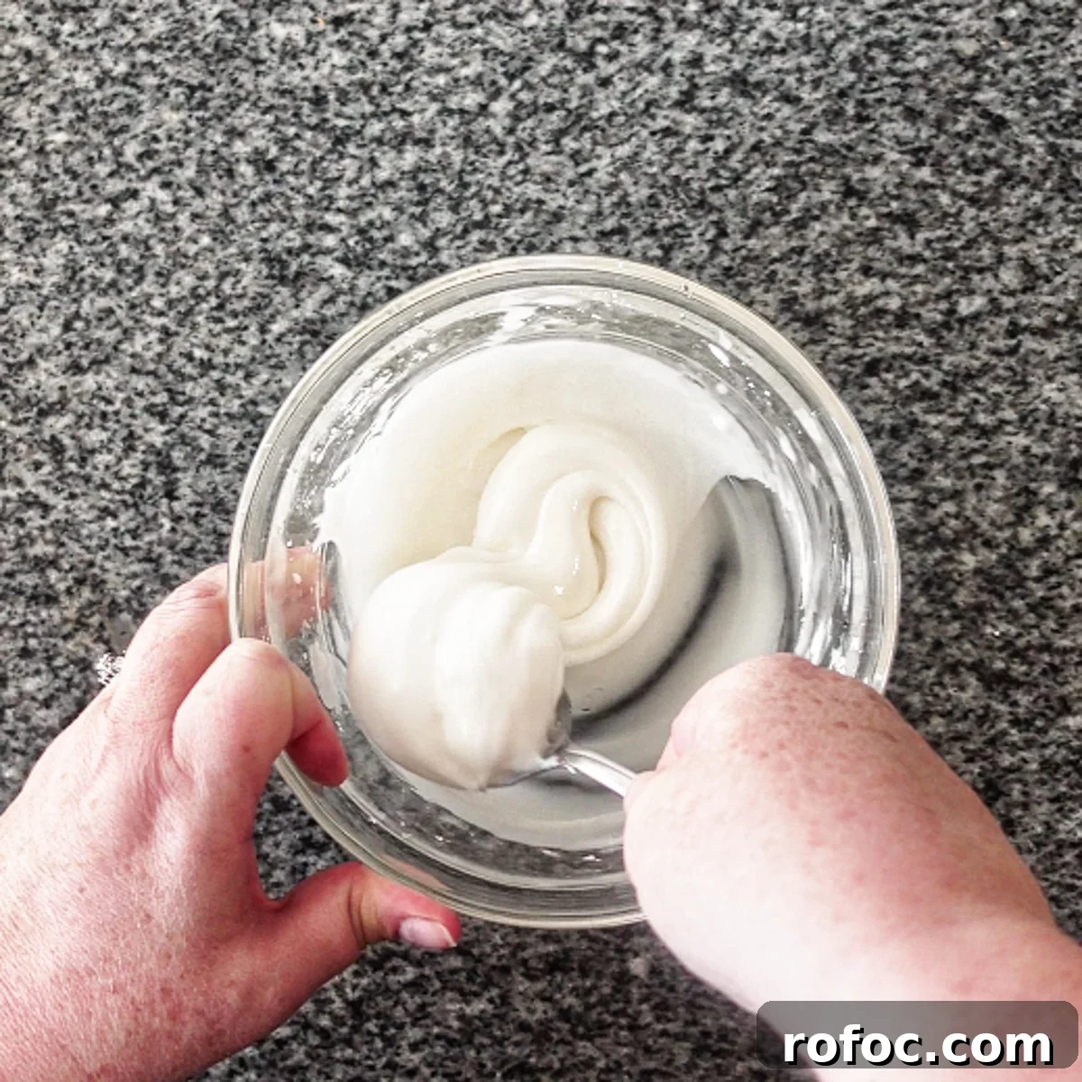 Gluten-Free Lemon Loaf: Starbucks Copycat Recipe for Moist Zest 13 stirring icing ingredients in small glass bowl with spoon.