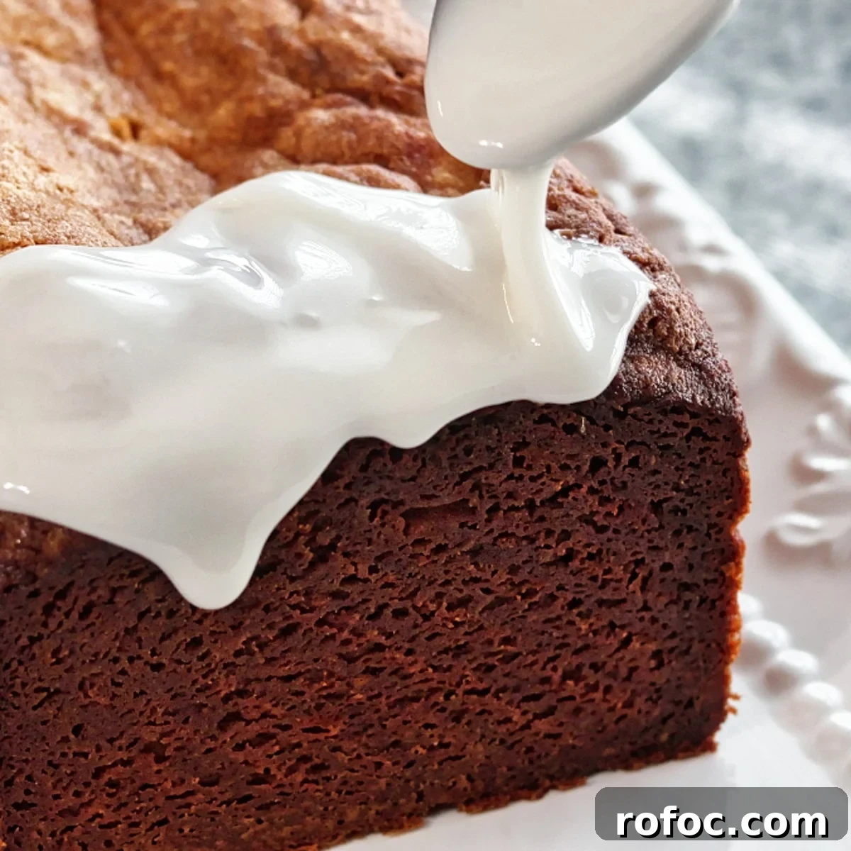 Gluten-Free Lemon Loaf: Starbucks Copycat Recipe for Moist Zest 14 pouring thick white glaze over top and down sides of lemon loaf cake.