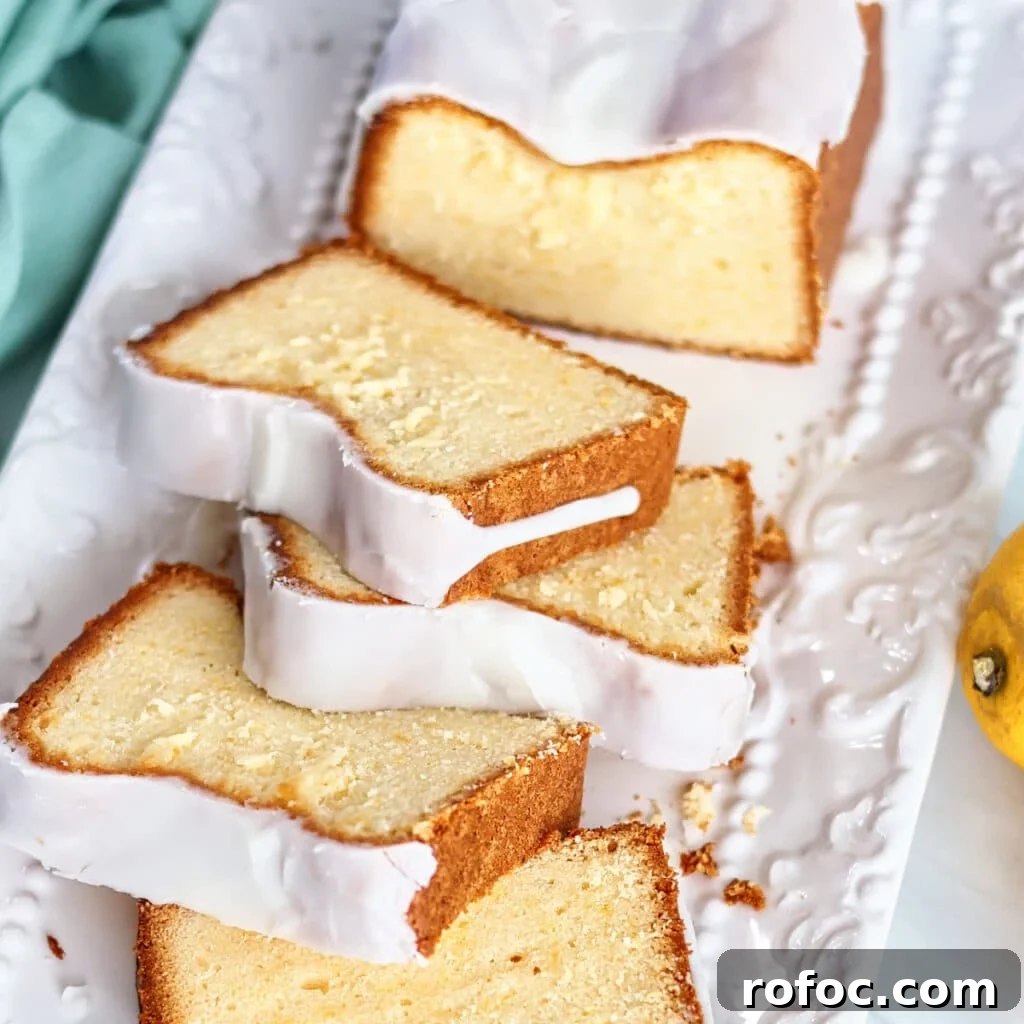 Gluten-Free Lemon Loaf: Starbucks Copycat Recipe for Moist Zest 15 slice of lemon loaf cake on a white decorative plate with fork cutting through.