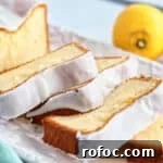 Gluten-Free Lemon Loaf: Starbucks Copycat Recipe for Moist Zest 16 slices of gluten free lemon loaf cake on white rectangular platter with whole lemons in the background.
