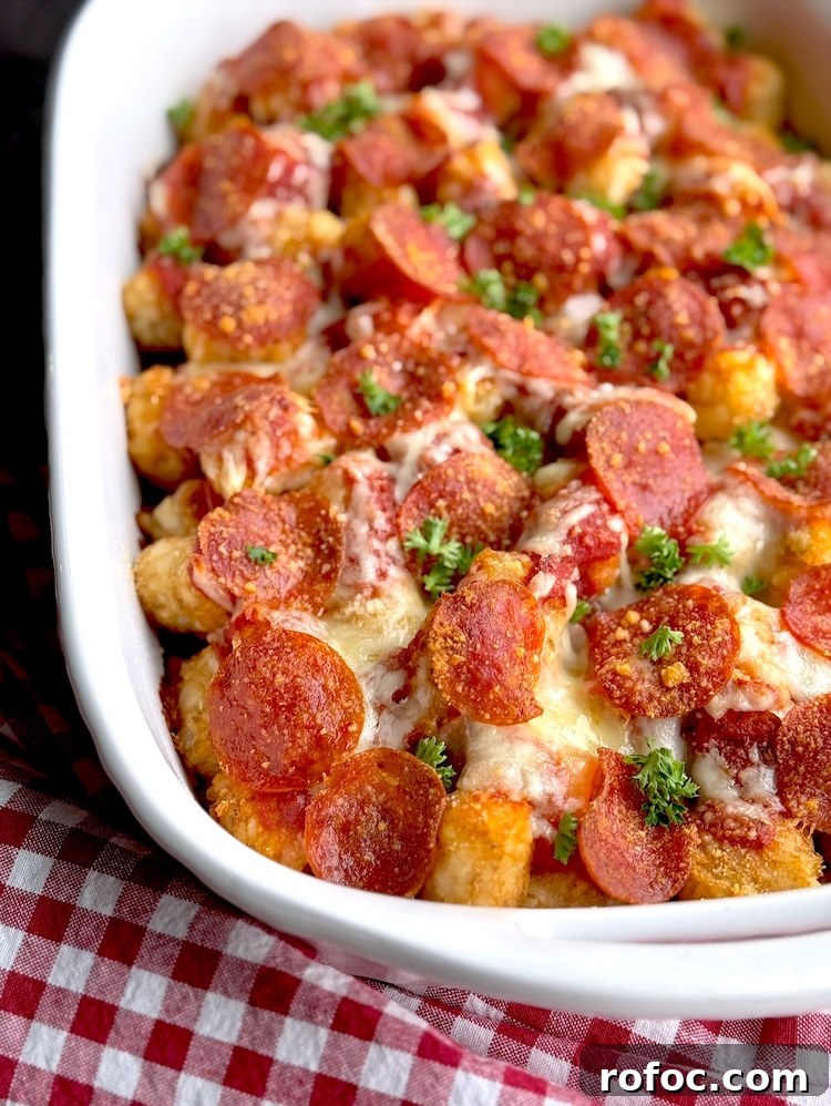 Tater Tot Pizza Casserole Recipe for Family Weeknight Meals 7 Crispy tater tots and pepperoni in a baking dish, cooked to perfection to make a yummy comfort food dinner for a large family with kids.