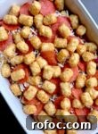 Tater Tot Pizza Casserole Recipe for Family Weeknight Meals 10 Frozen tater tots, pasta sauce, pepperoni, and mozzarella cheese all layered in a 9x13 baking dish ready to be baked in the oven.