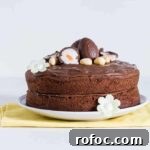 A side on view of a nutella cake with nutella frosting topped with cadbury creme eggs
