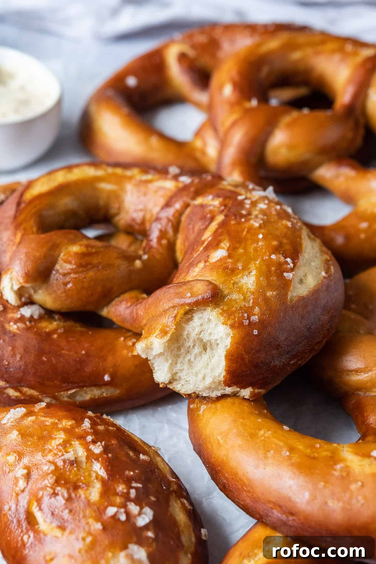 Vegan beer pretzels - these delicious vegan soft pretzels are made with (optional) beer to give them extra flavour. They are super soft, flavourful and easier to make than you might think! #veganbread #veganbaking #eggless #dairyfree close up of the crumb of a pretzel.
