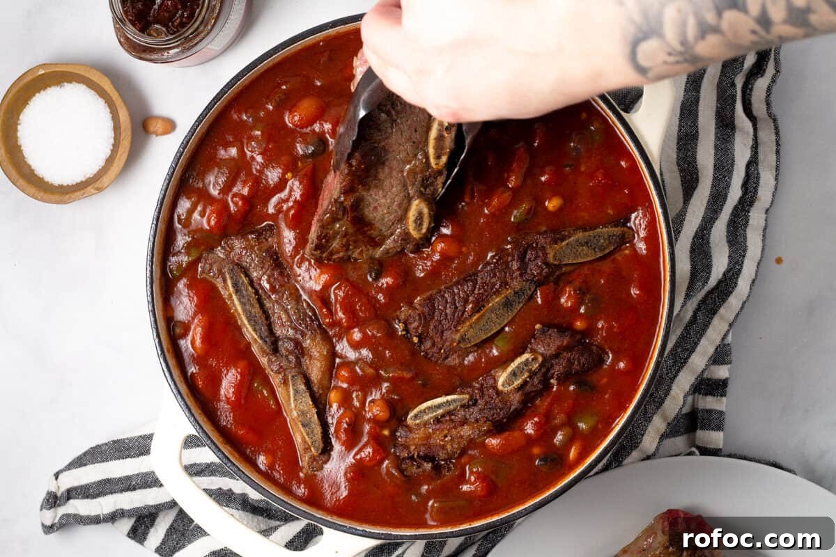 Large white pot filled with ingredients to make short rib chili