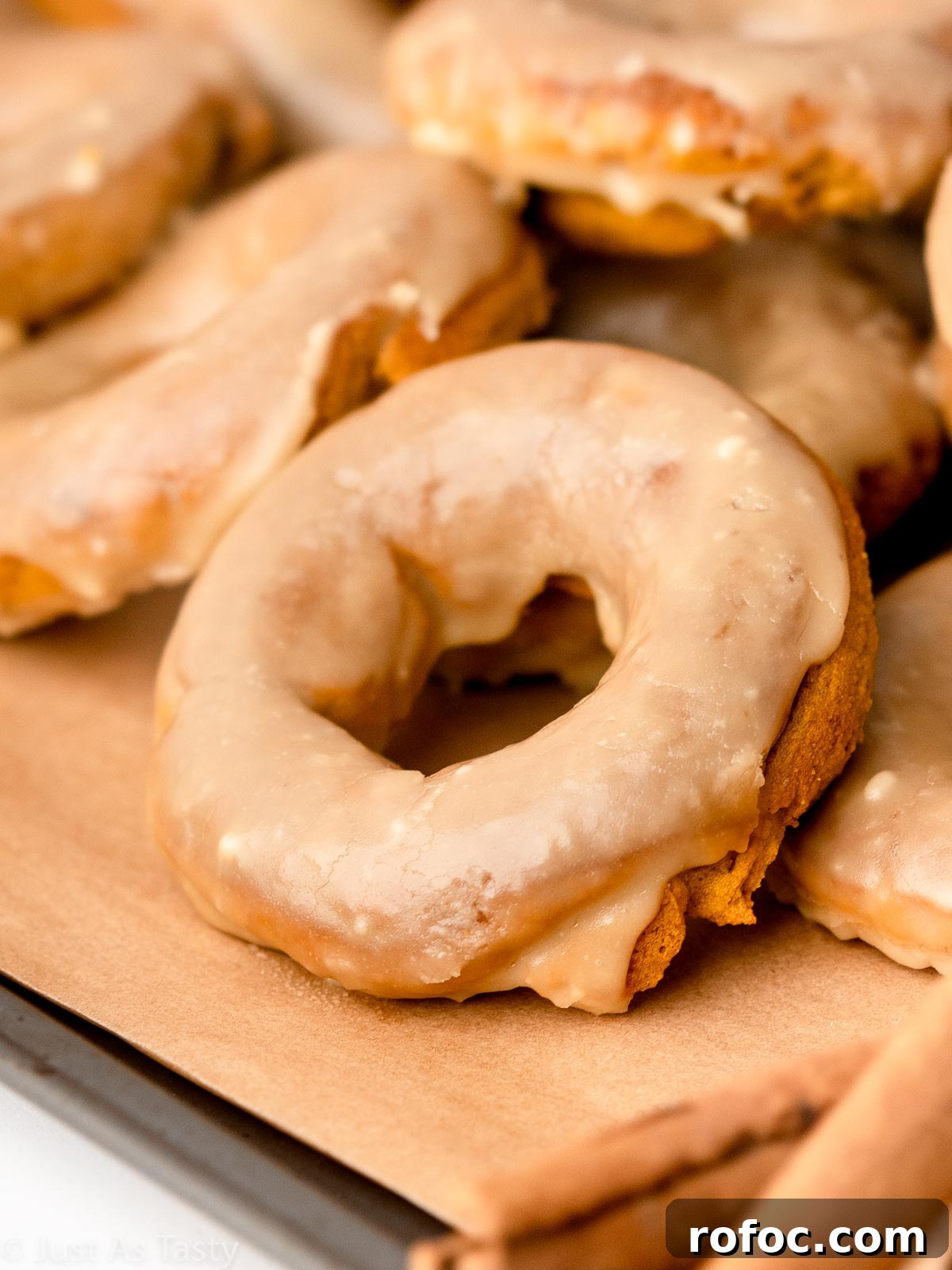 Pumpkin Spice Donuts with Maple Glaze: Fall Recipe Delight 2 Close-up of a glazed pumpkin spice donut.