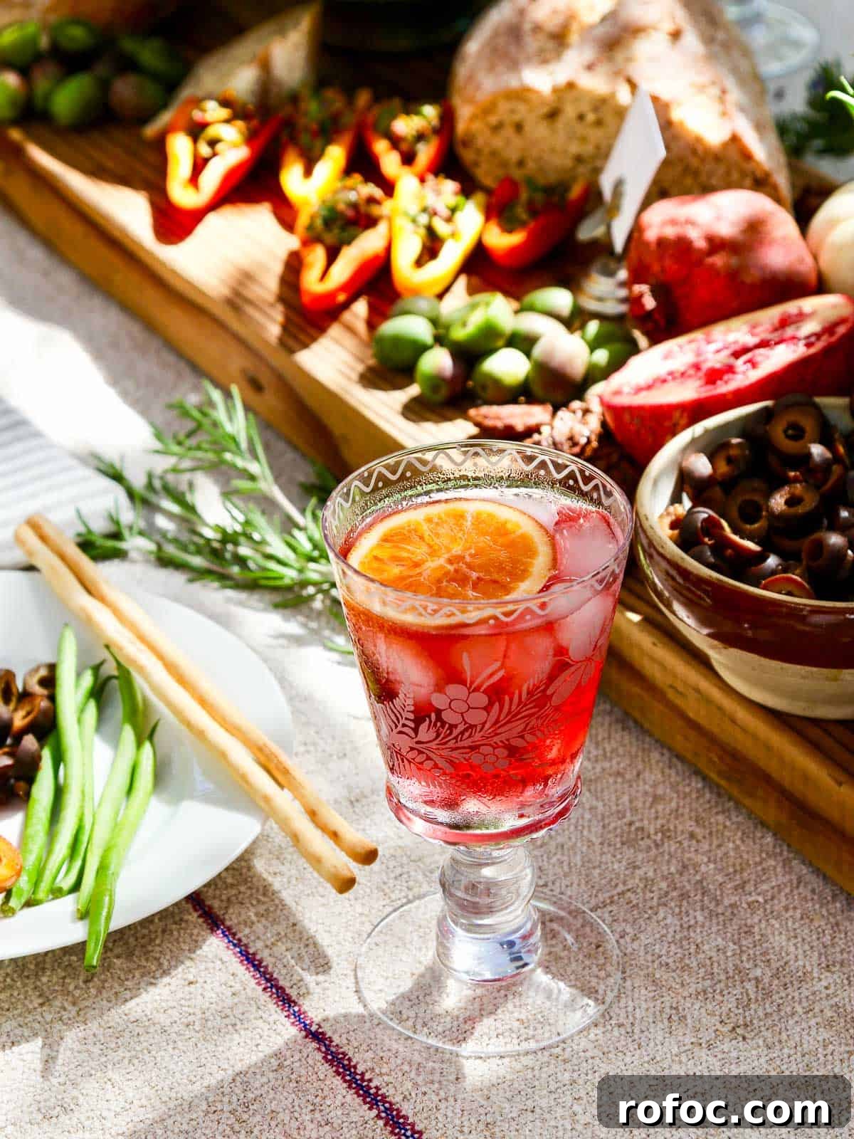 9 Refreshing Hibiscus Cocktail Recipes for Any Occasion 15 A fancy etched cocktail glass filled with a red hibiscus tea keto cocktail.