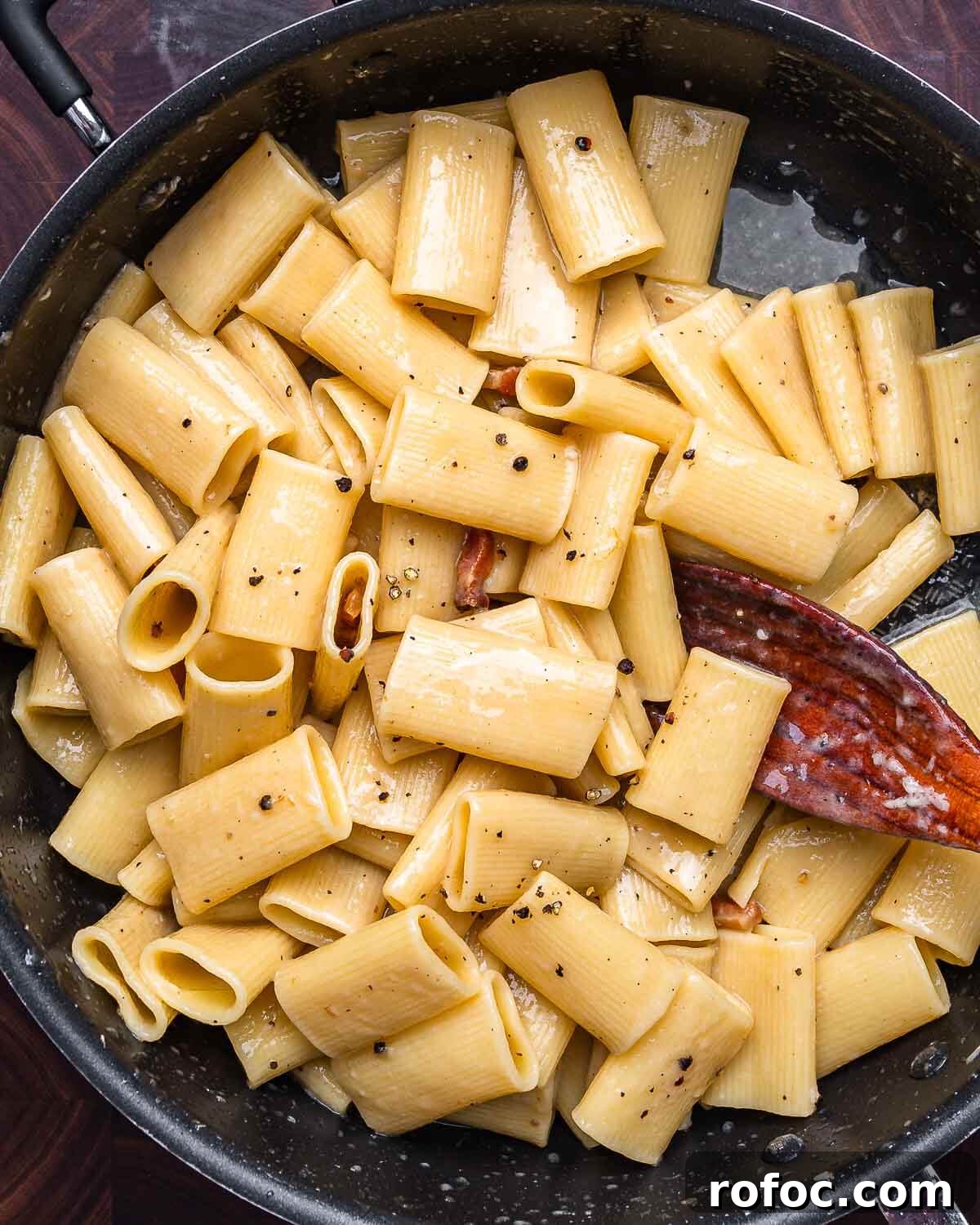 Rigatoni alla Gricia Recipe: Classic Roman Pork-Bacon Pasta 2 Overhead shot of rigatoni alla gricia in black pan.