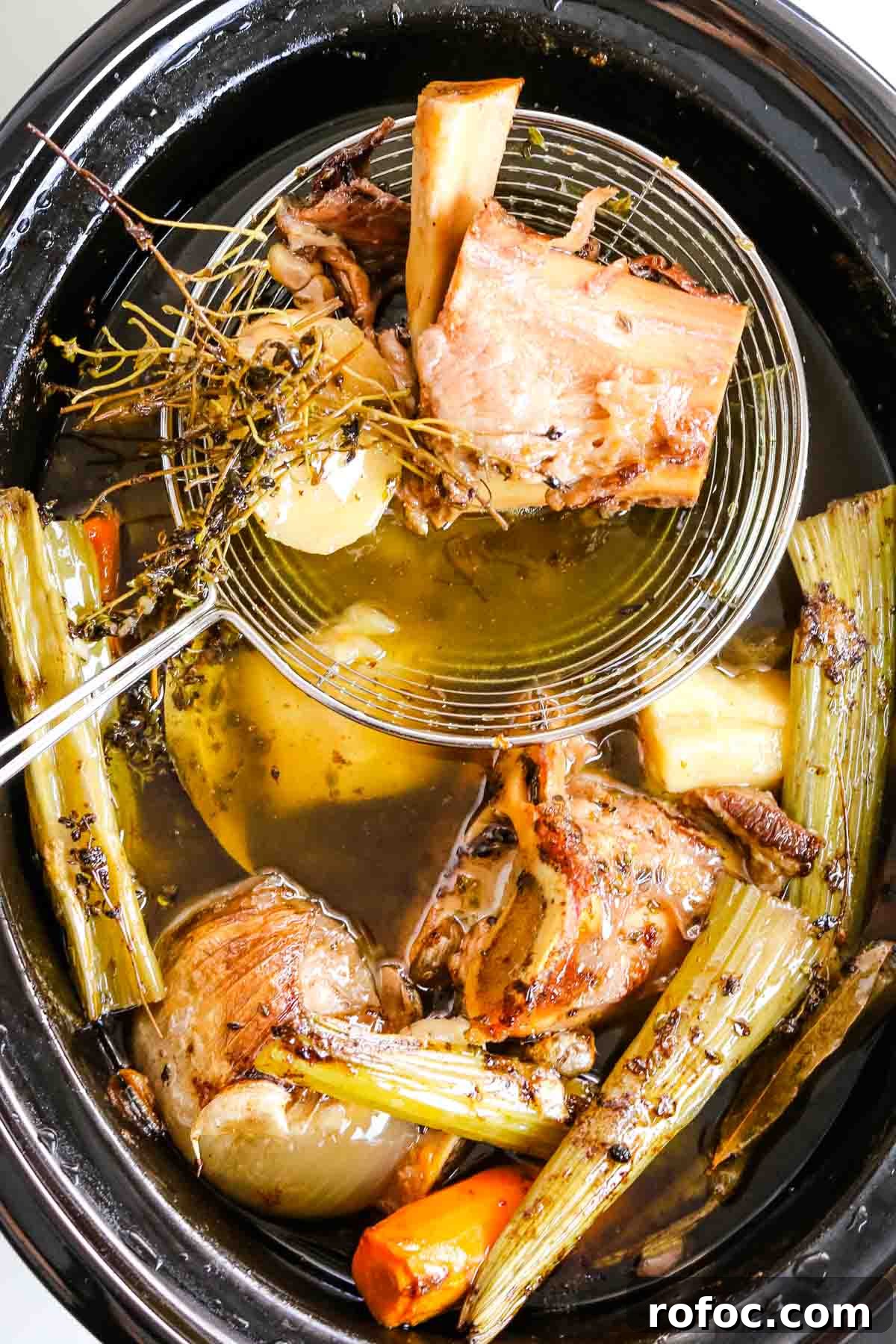 Rich Homemade Beef Bone Broth Recipe for Deep Flavor and Nutrition 12 removing bones from bone broth.