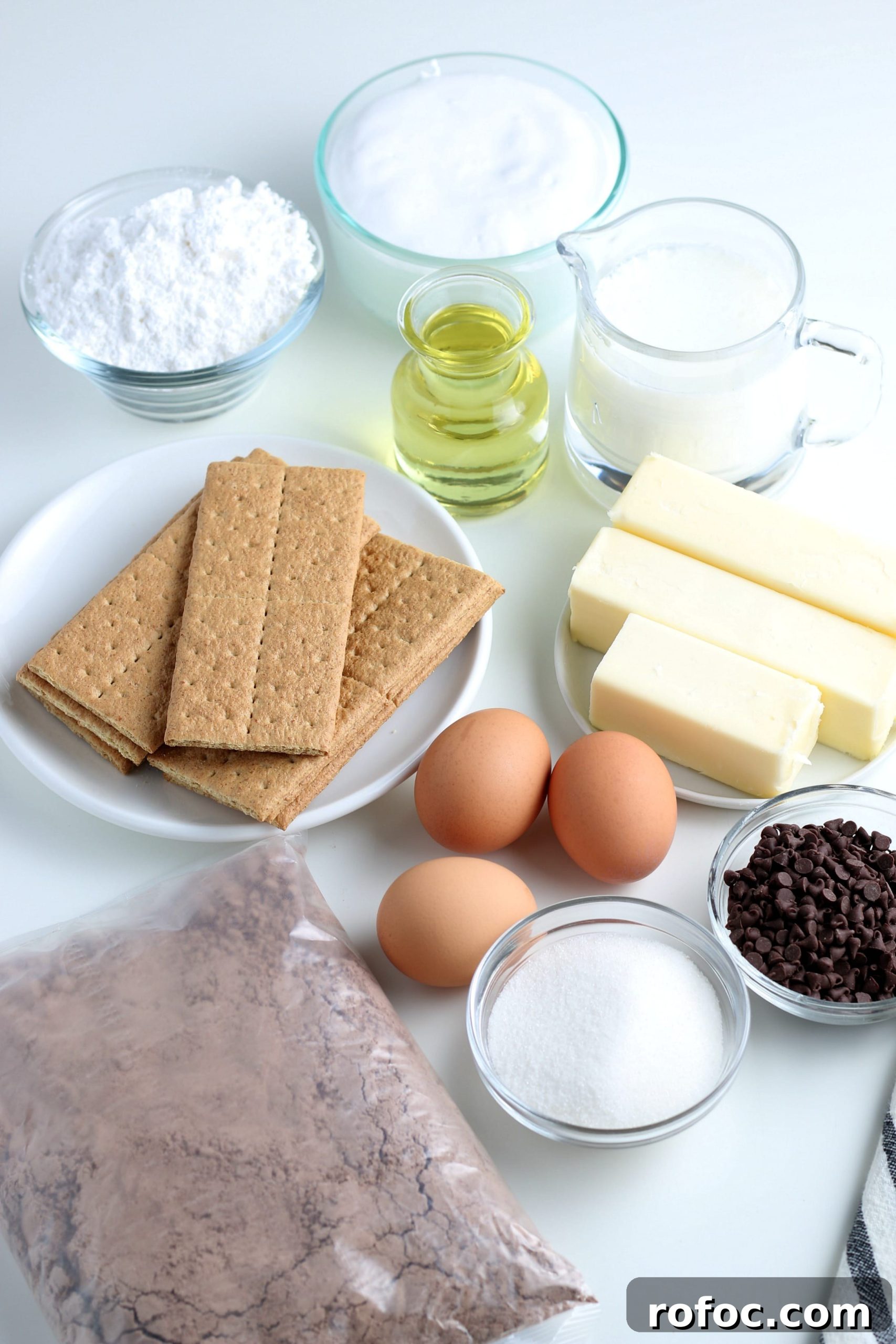 ingredients for s'mores cupcakes laying out on a white countertop.