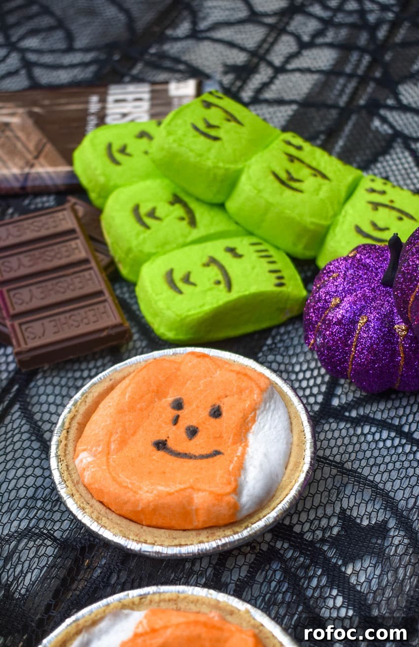 halloween mini s'more pie with hershey bars and green peeps in the background