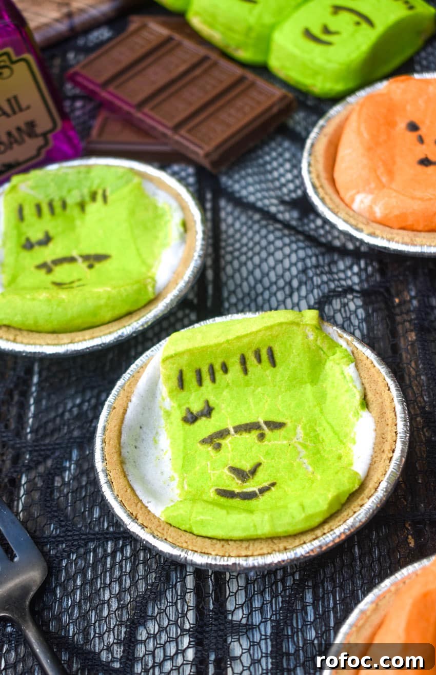 halloween mini s'more pies with hershey bars and green peeps in the background