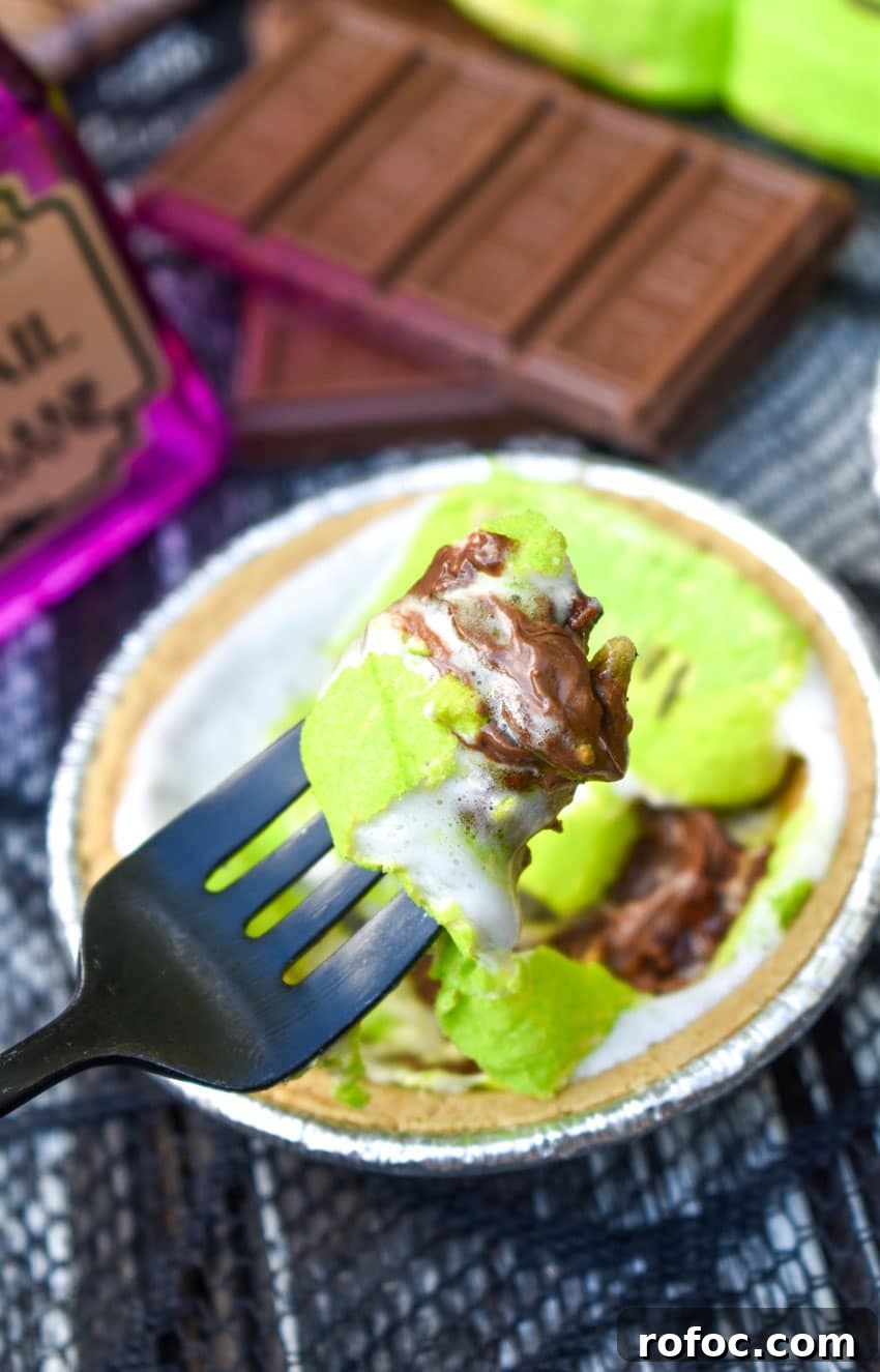 a black fork holding up a scoop of a halloween mini s'mores pie