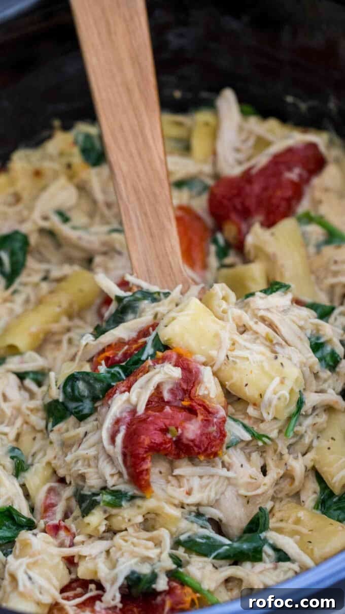 Tuscan Chicken Pasta Made in a Slow Cooker: Creamy One-Pot Meal 2 Creamy Tuscan pasta with sun dried tomatoes and cheese in the crockpot