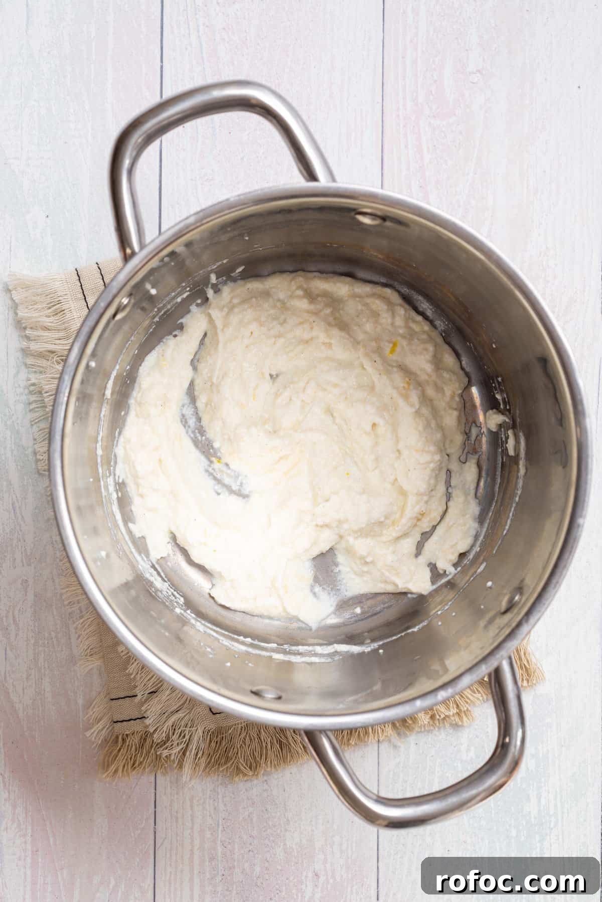 Creamy Lemon Ricotta One-Pot Pasta Recipe 5 Overhead view of a large pot with mixed ricotta, parmesan, lemon zest, lemon juice, salt, and pepper.