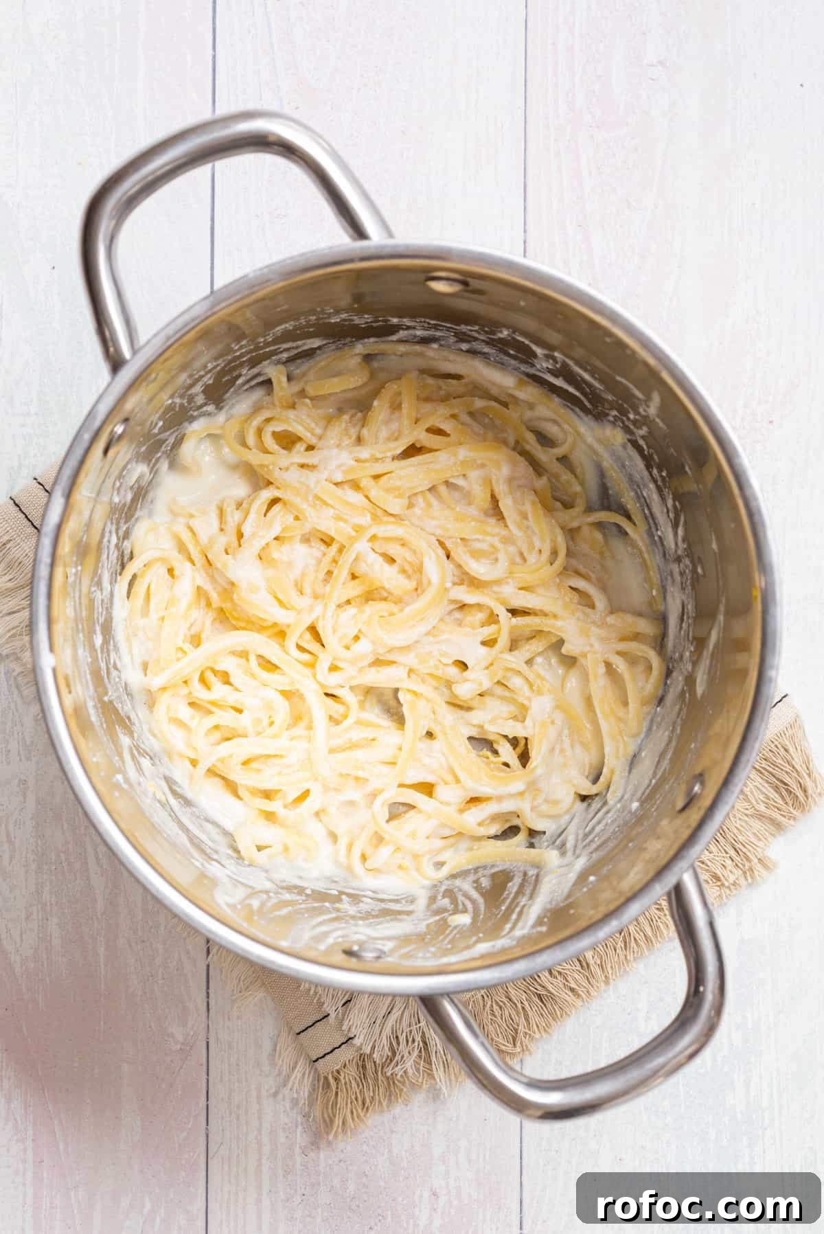 Creamy Lemon Ricotta One-Pot Pasta Recipe 7 Overhead view of mixing the pasta and cheesy sauce in a large pot.