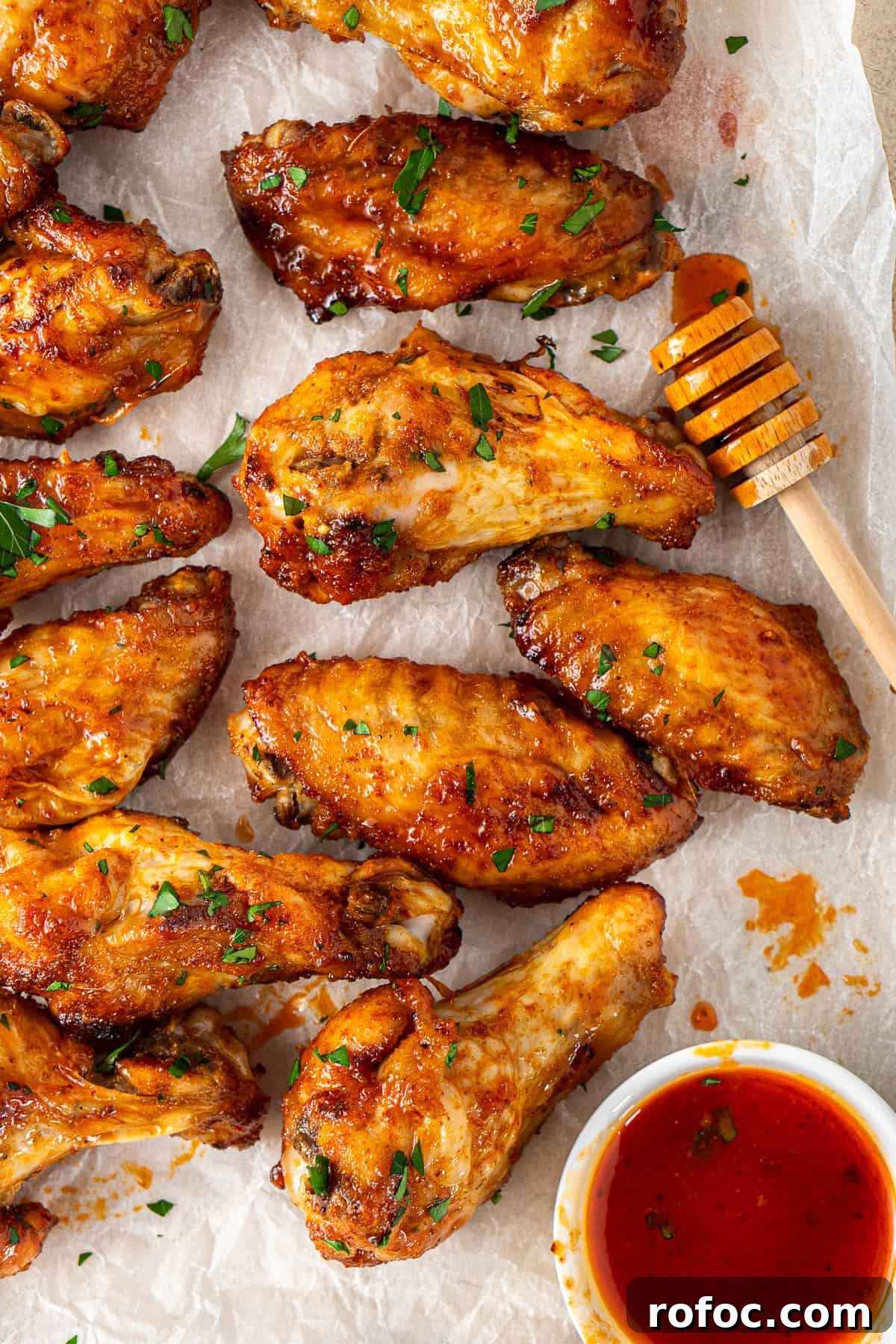 Spicy Honey-Glazed Chicken Wings Recipe for Game Day 2 Close up of hot honey chicken wings with extra sauce.