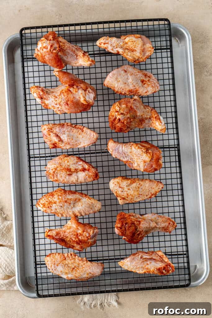 Spicy Honey-Glazed Chicken Wings Recipe for Game Day 6 The spiced chicken wings on a wire rack on a tray.