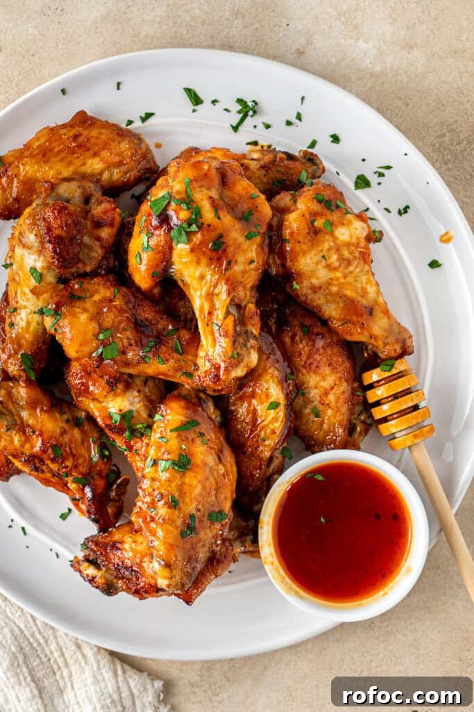 Spicy Honey-Glazed Chicken Wings Recipe for Game Day 10 The hot honey chicken wings served up on a plate.