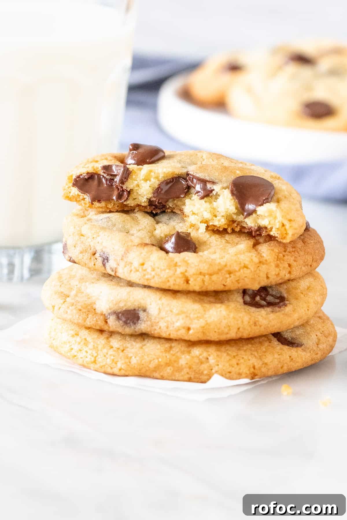 Chewy Chocolate Chip Cookies Made Without Brown Sugar 5 Stack of chewy chocolate chip cookies, with the top cookie broken in half