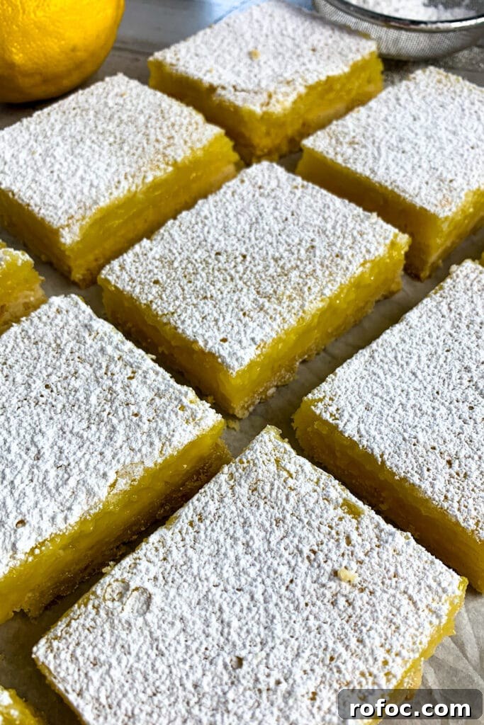 Zesty Lemon Bars Recipe: Bright, Tangy Dessert Bars 2 Lemon bars dusted with powdered sugar and ready to eat.