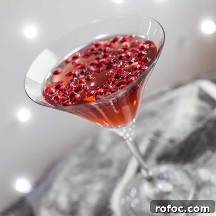 Sparkling Pomegranate Popper Cocktail Recipe for Parties 4 a cocktail glass on a silver tray filled with Pomagranate Popper Cocktail