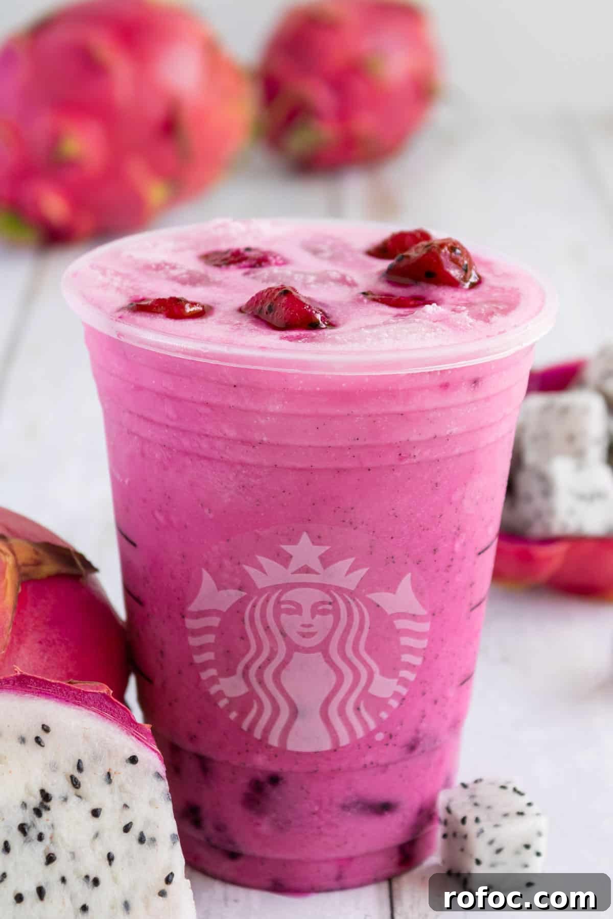 Starbucks Dragon Drink Guide: Ingredients, Nutrition & How to Order 8 Cup of dragon drink surrounded by dragonfruit.