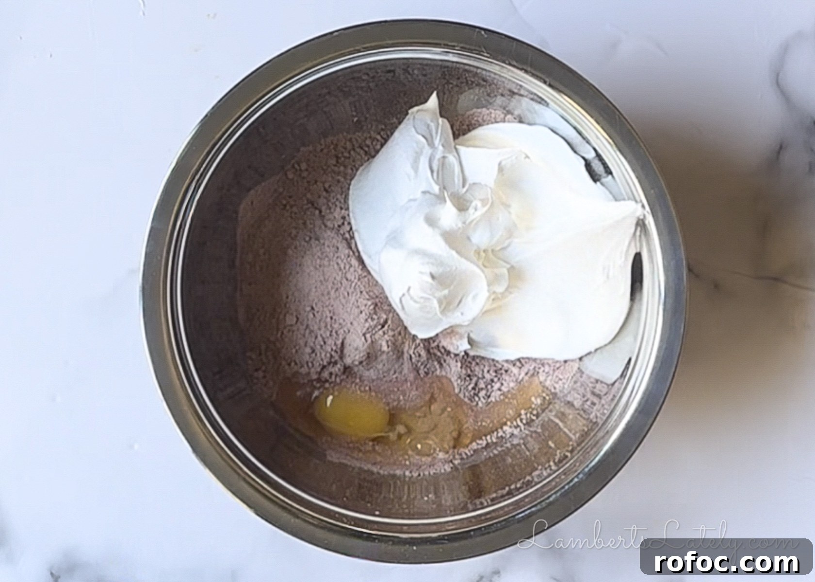 egg, cool whip, and red velvet cake mix combined in a bowl.