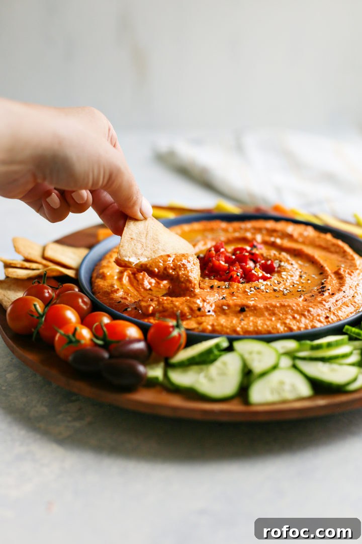Top Super Bowl Dip Recipes for Game Day Gatherings 24 woman eating a bowl of dips for Super Bowl