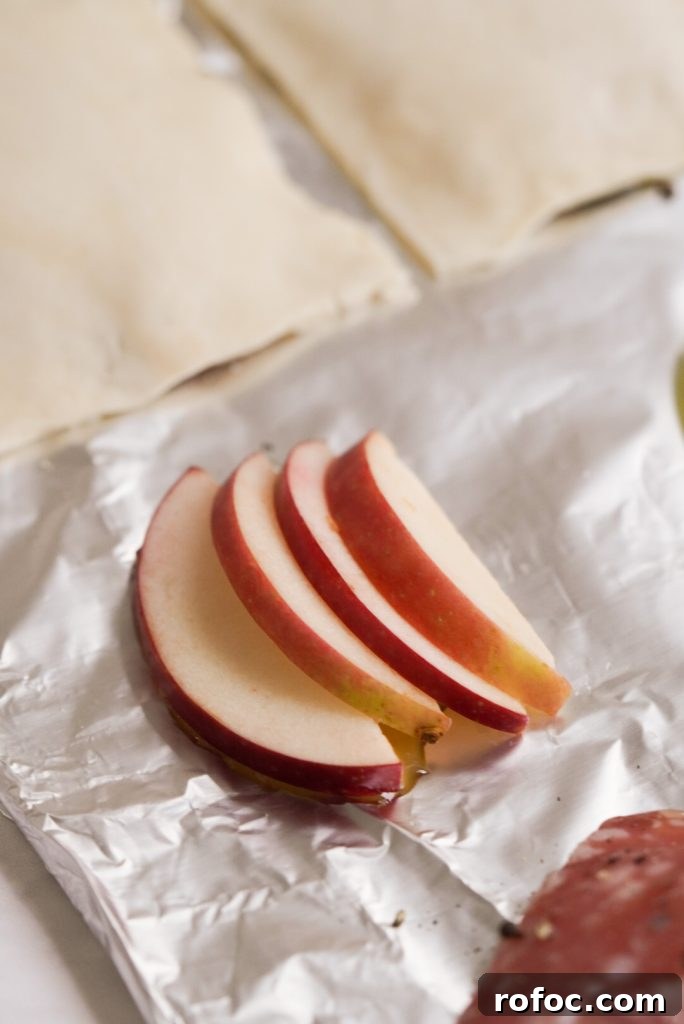 Baked Goat Cheese Tarts: Simple Party Appetizer Recipe 5 apple slices layered on a baking sheet