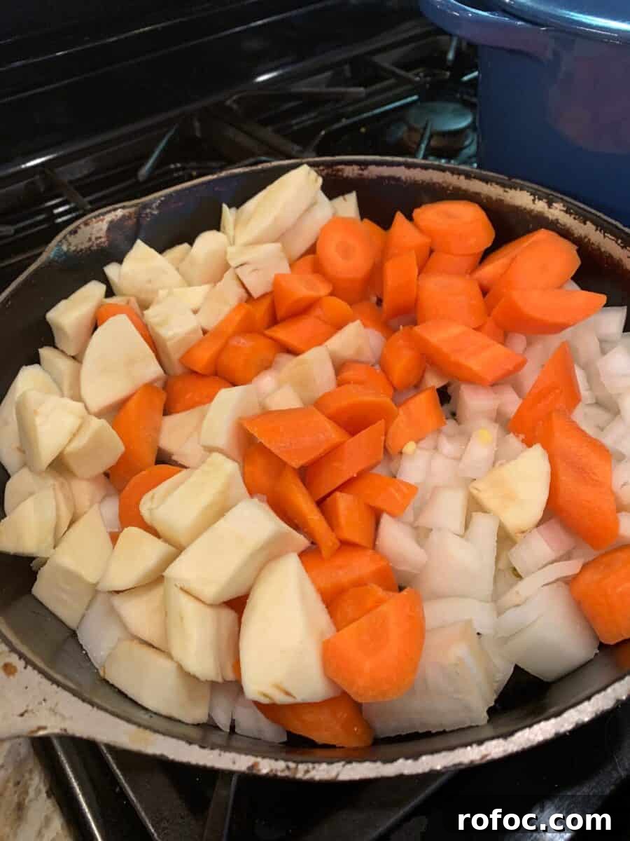Traditional Irish Beef Stew Recipe for Hearty Weeknight Dinners 6 Parsnips, carrots and onion in a skillet.