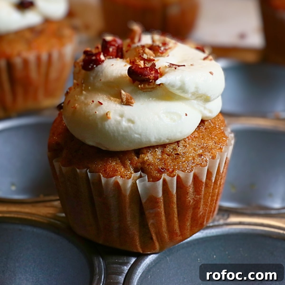 Moist Carrot Cake Cupcakes with Cream Cheese Frosting 16 homemade carrot cake cupcakes frosted with cream cheese frosting on top on a cupcake pan