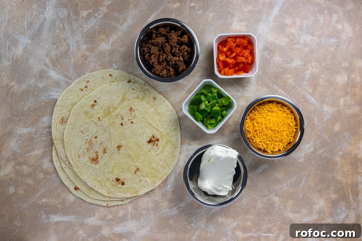 Taco Meat Pinwheels: Quick Party Appetizers from Leftovers 3 Ingredients measured out in individual containers with flour tortillas on the side.